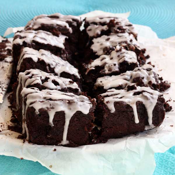 beetroot & ginger brownies on baking paper and a blue cloth