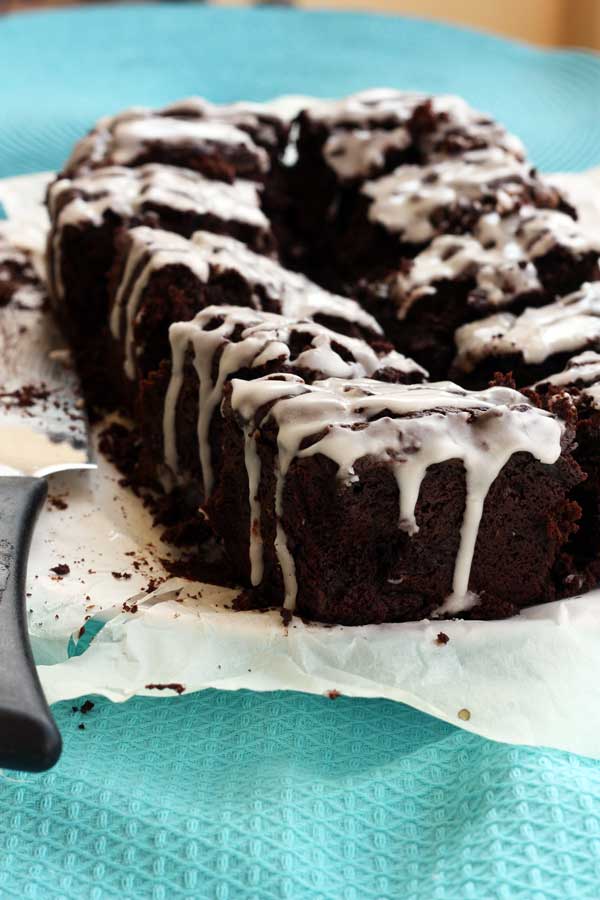 Beetroot &amp; ginger brownies on baking paper and a blue cloth