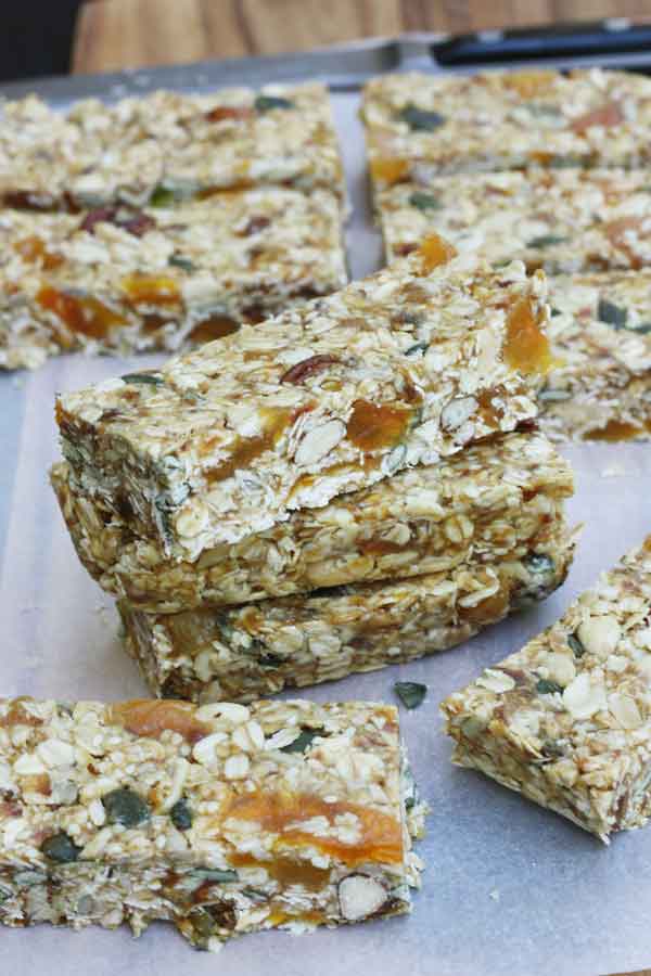 A stack of no bake granola bars on baking paper