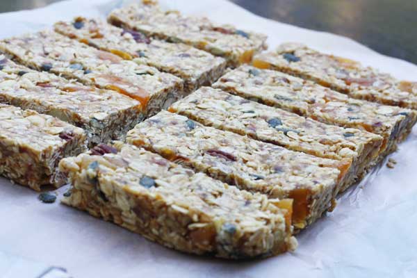 No bake granola bars just sliced on baking paper.