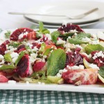 Blood orange and roasted fennel & radish salad on a square plate and checked green mat