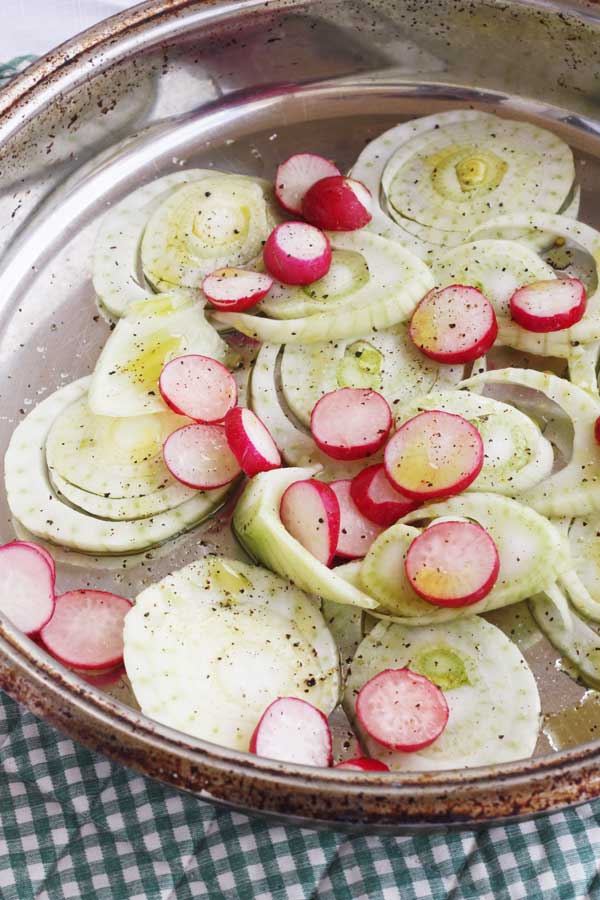 fennel and radishes cut up and ready to be roasted for a salad