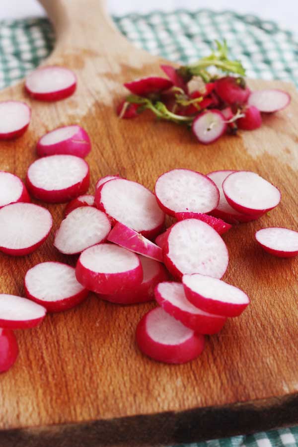 chopped radishes on a wooden cutting board