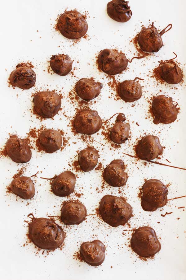 Chocolate orange truffles from above on a white background