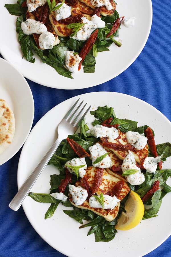 halloumi salads on white plates and blue backgrounds from above