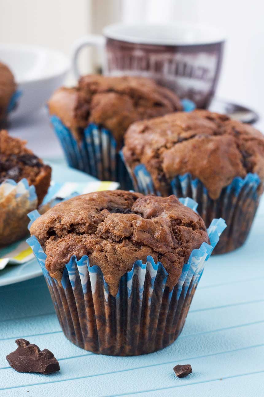 Soft-centred triple chocolate muffins on a blue background