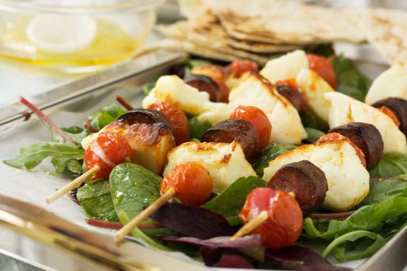 Halloumi kebabs with chorizo, tomatoes and honey lime dressing