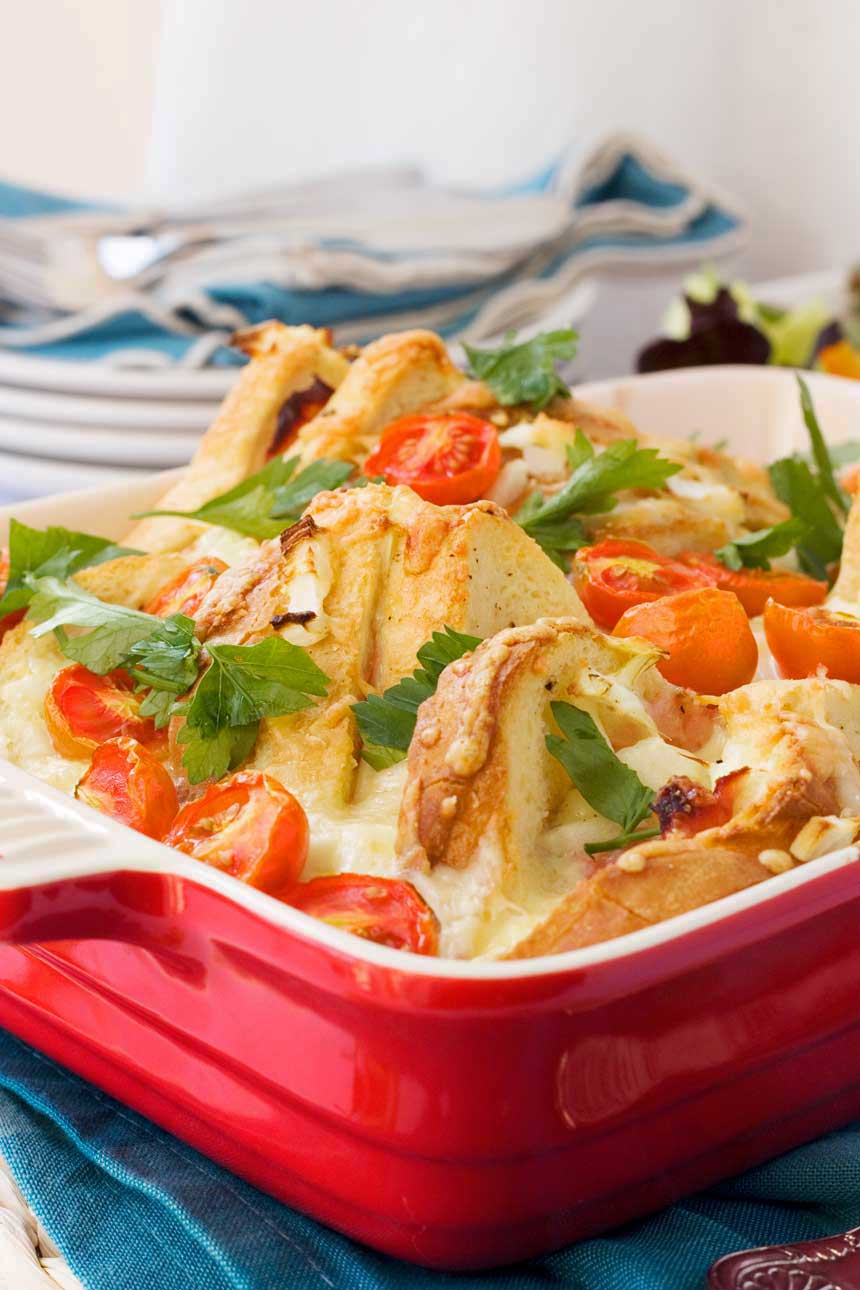 A croque monsieur brunch bake close up in a red baking dish.