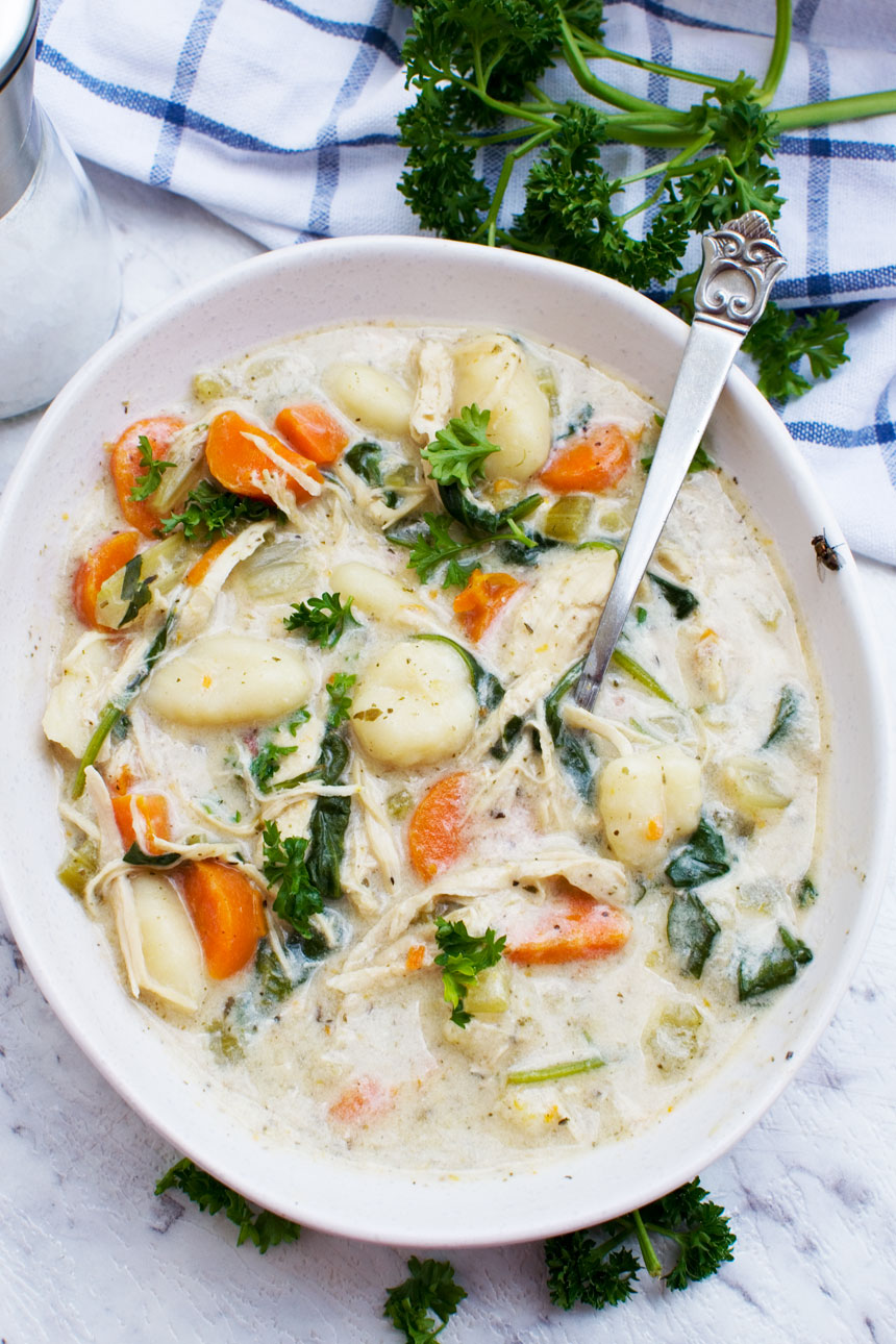 An overhead image of crockpot chicken gnocchi soup from Olive Garden