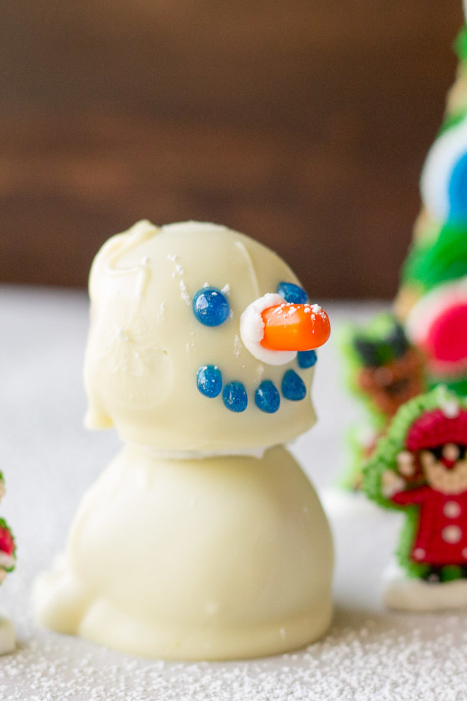 A close up of some no bake peanut butter balls shaped like a snowman.