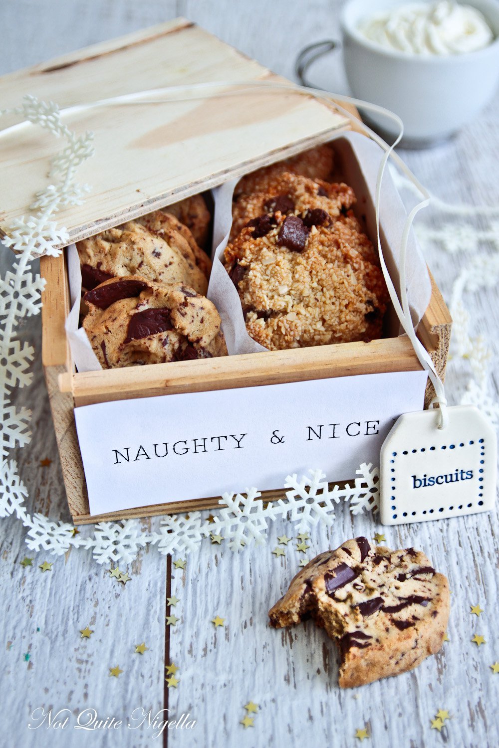 Naughty and Nice cookies from Not Quite Nigella in a nice gift box and on a white wooden table.