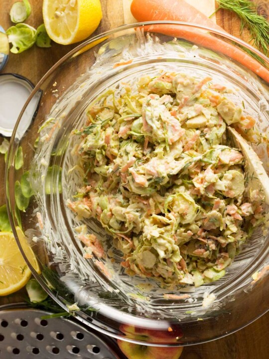 Clear bowl of brussels sprouts coleslaw from above.