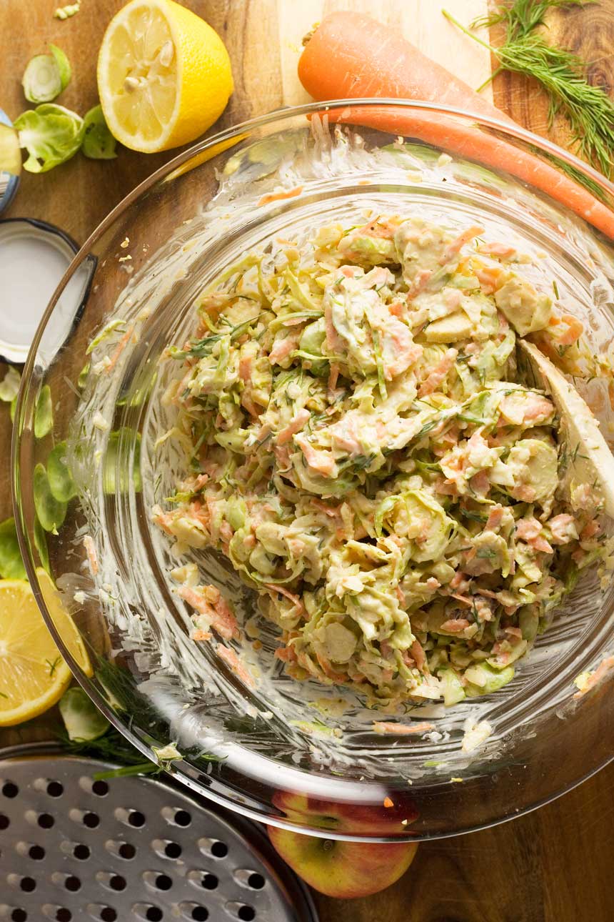 Clear bowl of brussels sprouts coleslaw from above.