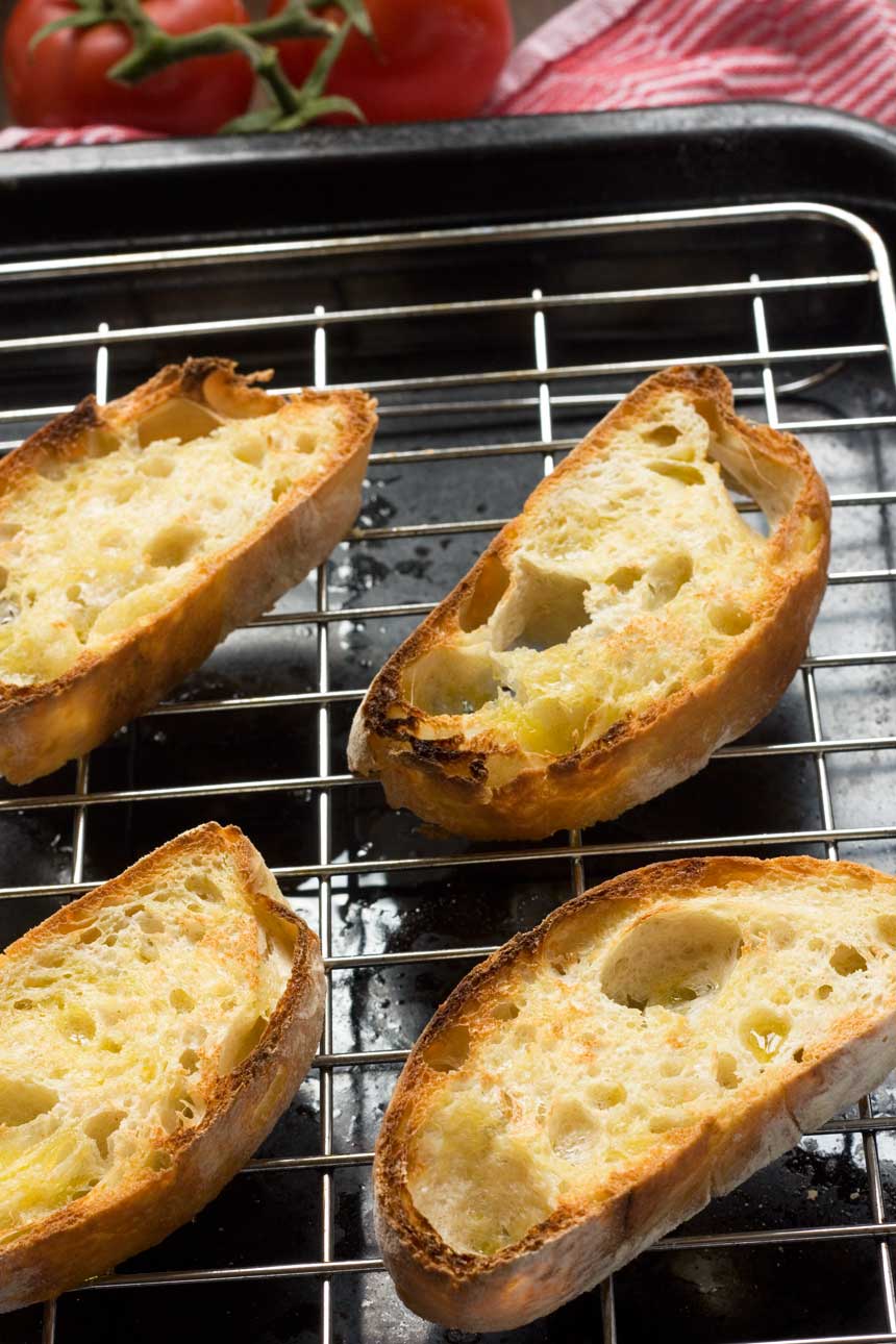 Grilled bread for pan con tomate on a grill from above