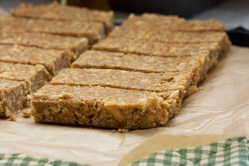 Homemade sweet and salty peanut granola bars on baking paper without the topping