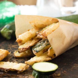 A brown baking paper bag of zucchini fries