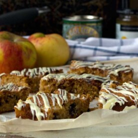 sticky apple ginger cake bars on baking paper with ingredients in the background