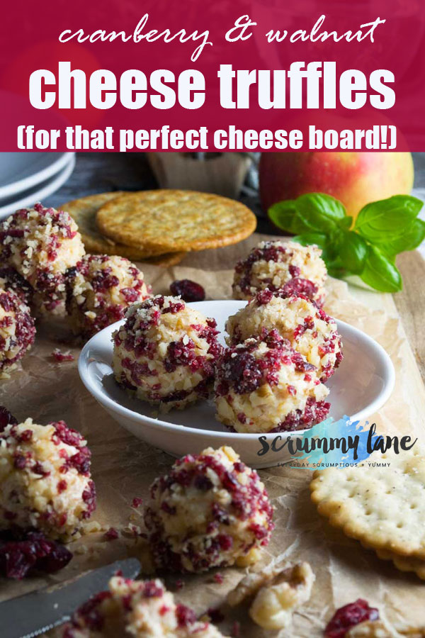 cheese truffles with cranberries and walnuts on a cheese board for Pinterest