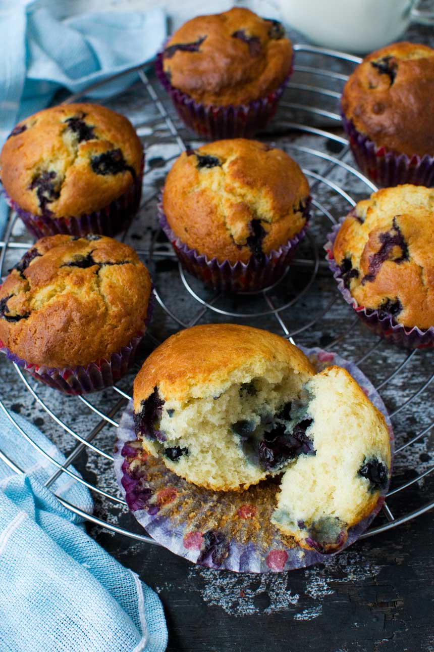 Greek yogurt blueberry muffins on a cooling rack from above.