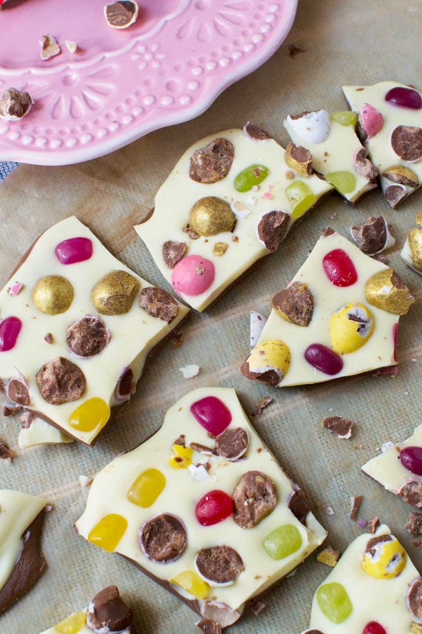 Pieces of Easter chocolate bark on brown paper from above.