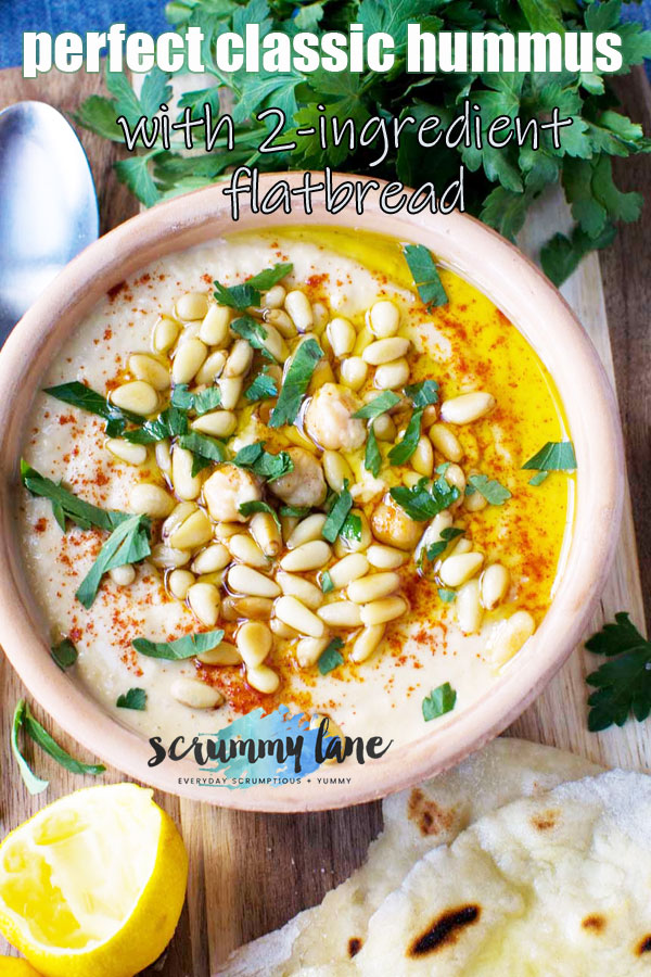 A clay pot of classic hummus sprinkled with pine nuts and paprika - image for Pinterest