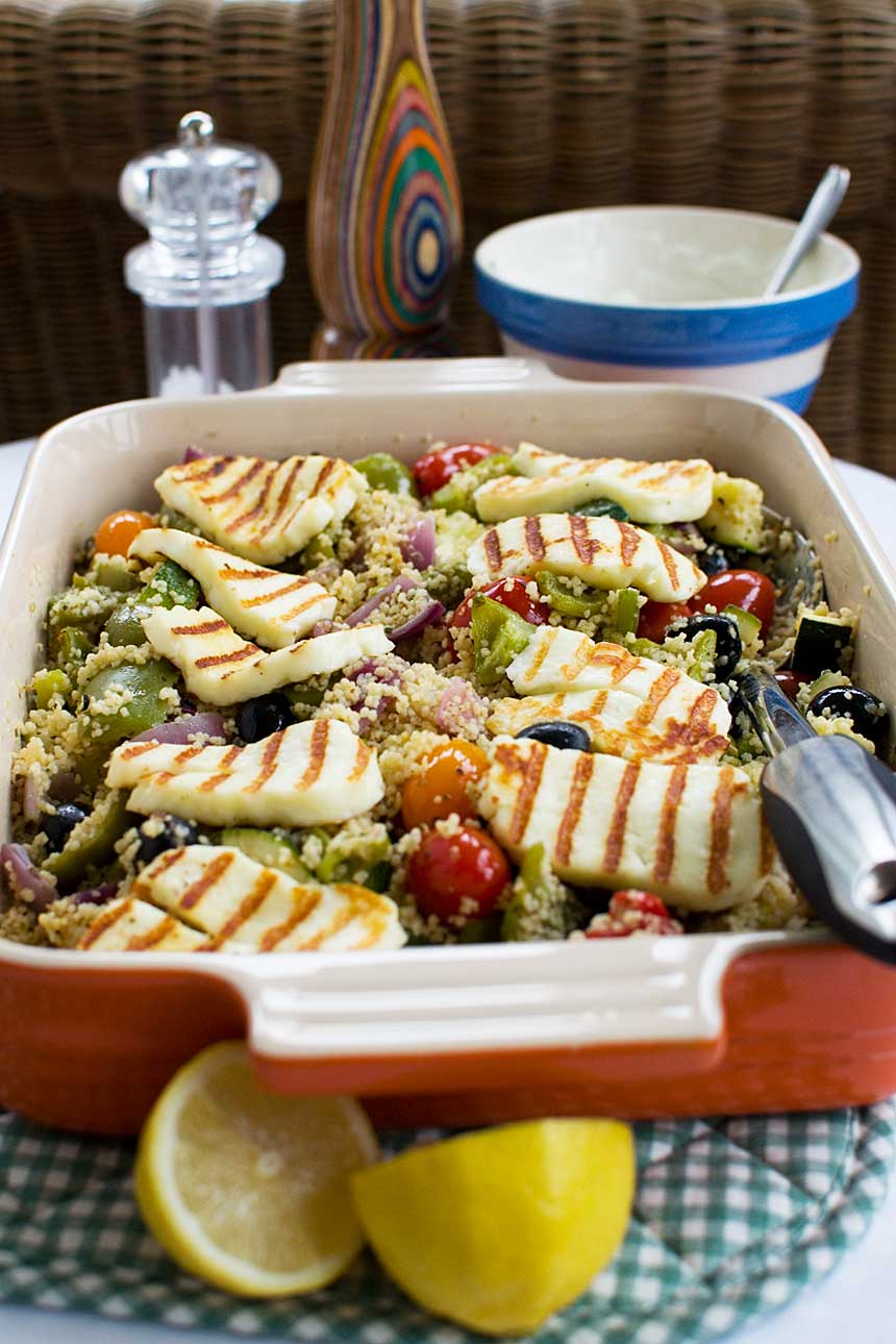 One pan Greek couscous with halloumi in a red baking dish