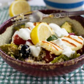 One pan Greek couscous with halloumi in a rustic bowl and on a green checked place mat