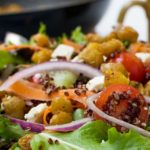 A close up of crispy fried chickpeas on a salad