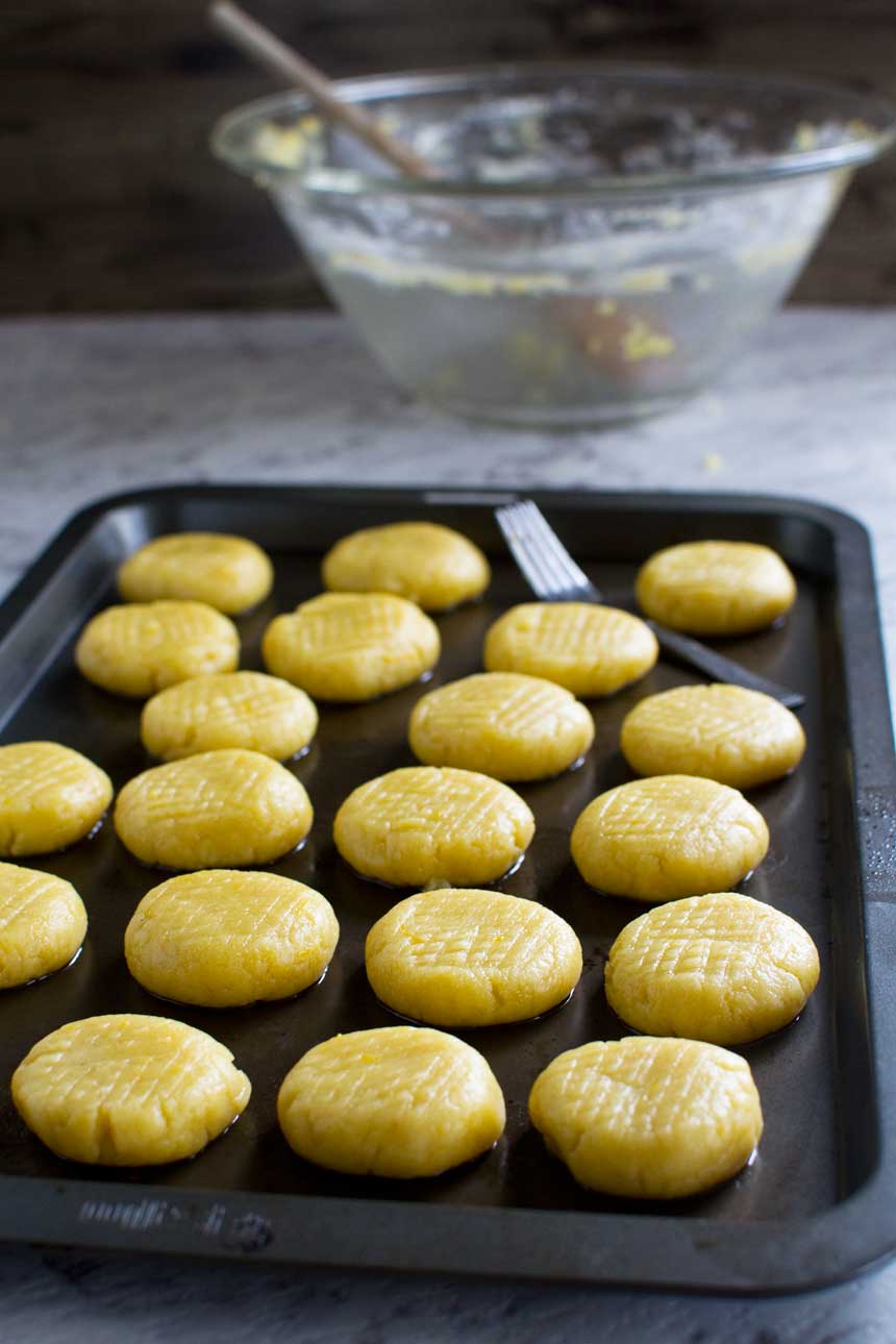 Raw Greek Christmas honey cookies on a baking tray ready to be baked