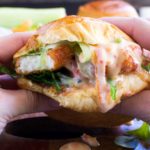 Someone eating a crispy halloumi burger up close