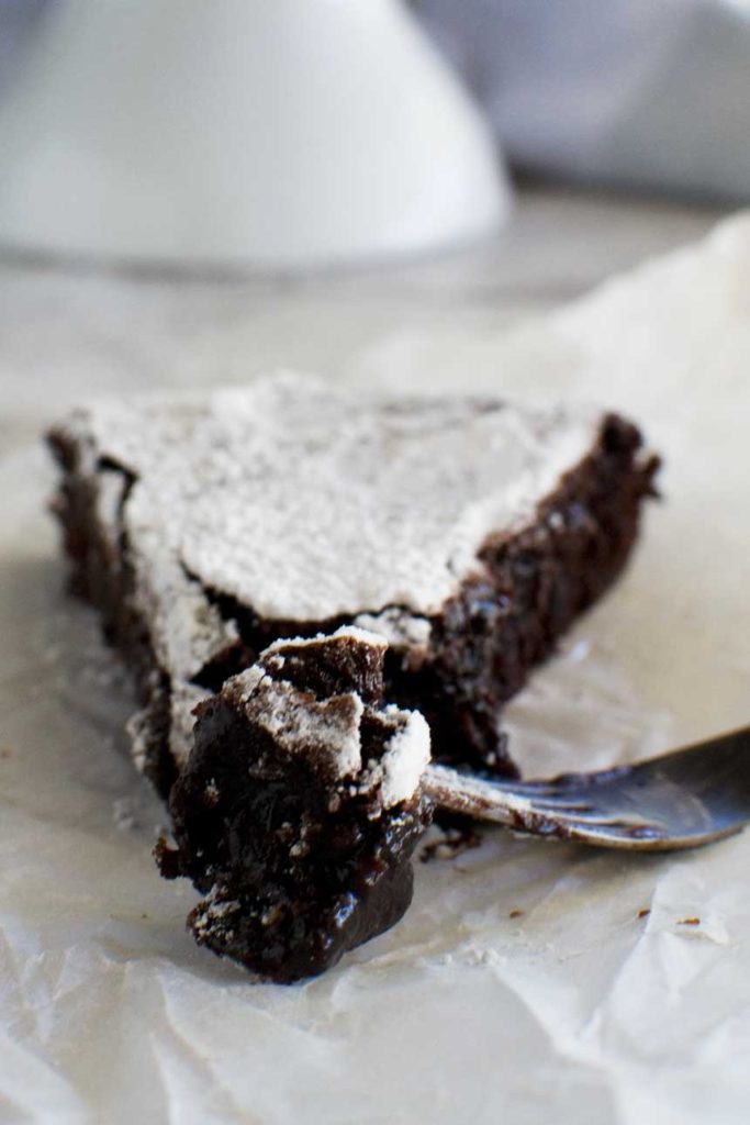 A close-up of a piece of 6-ingredient gooey Swedish chocolate cake (kladdkaka)