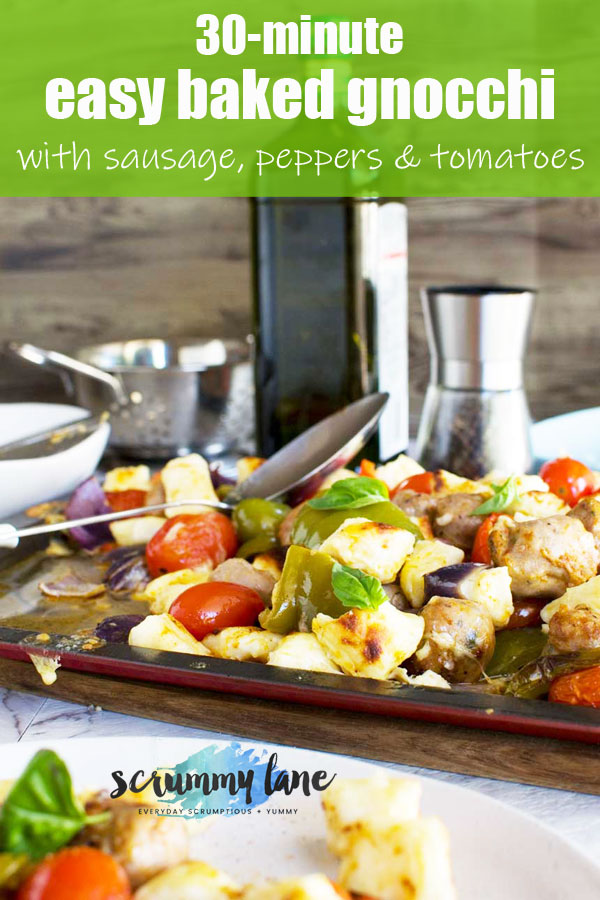 A baking tray of baked gnocchi with sausage, peppers and tomatoes for Pinterest