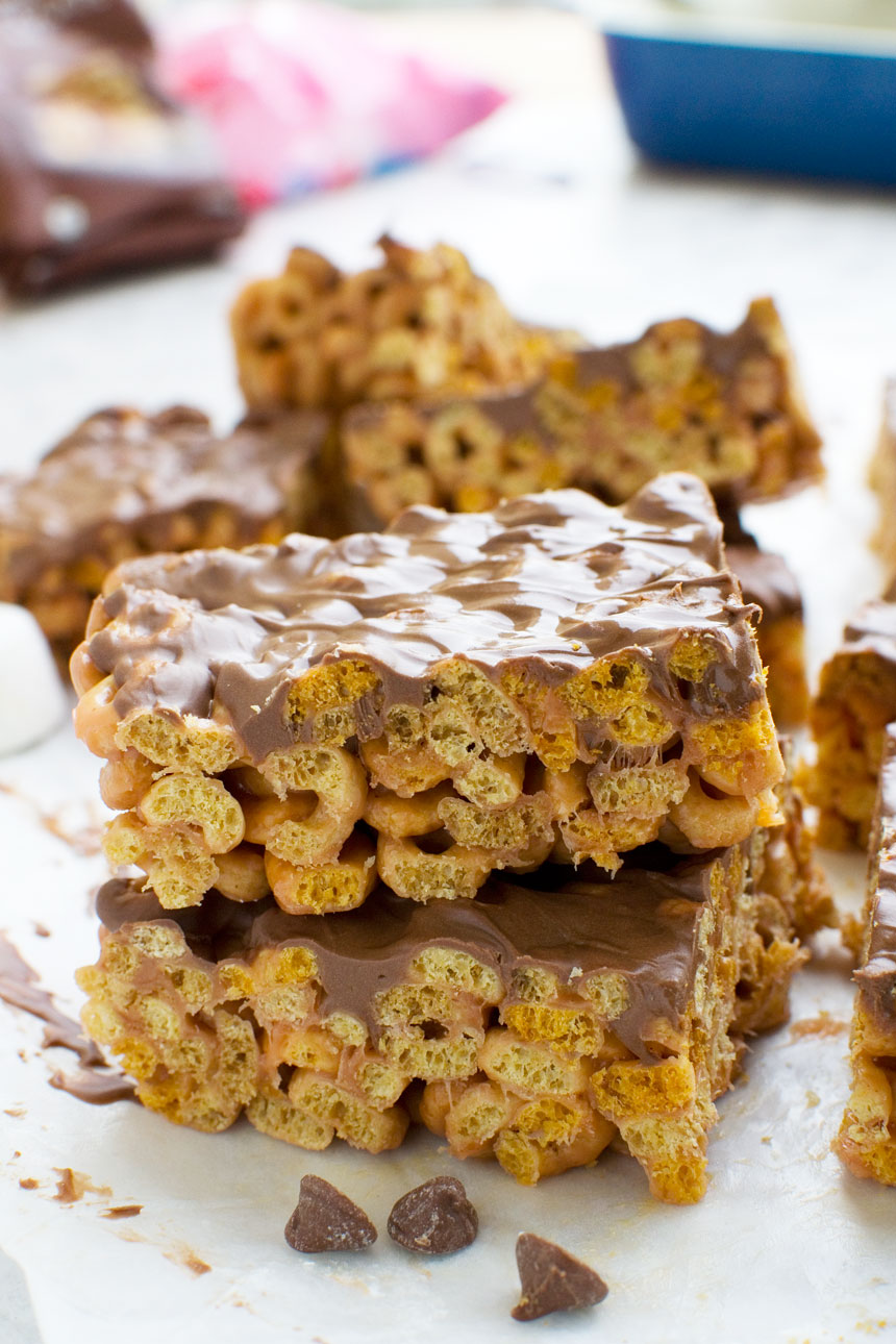 Two peanut butter cheerio bars stacked on top of each other, with others in the background
