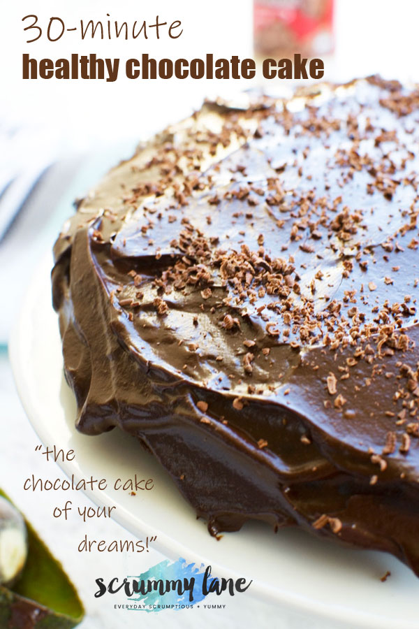 A whole healthy chocolate cake covered with avocado frosting