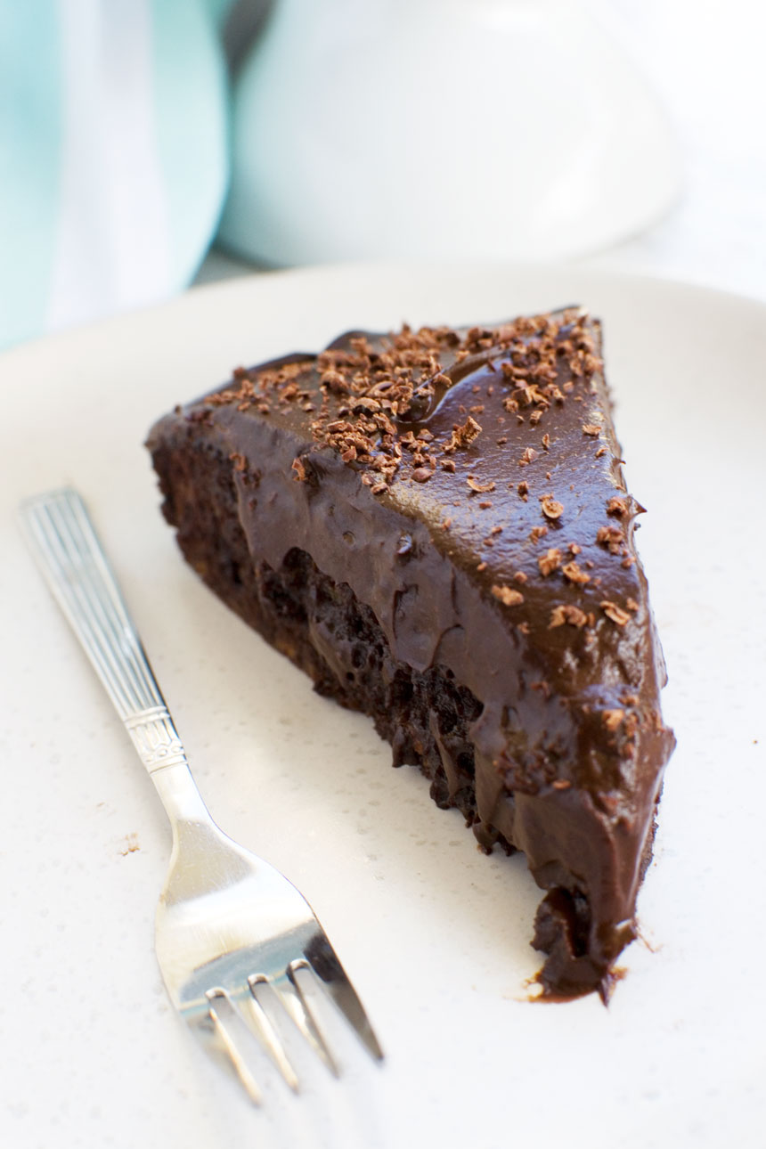 Slice of 30 minute healthy chocolate cake on a white plate and with a fork