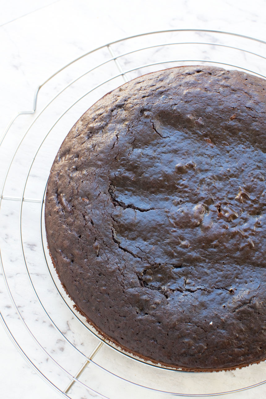 View of the top of  a 30 minute healthy chocolate cake just out of the oven on a cooling rack