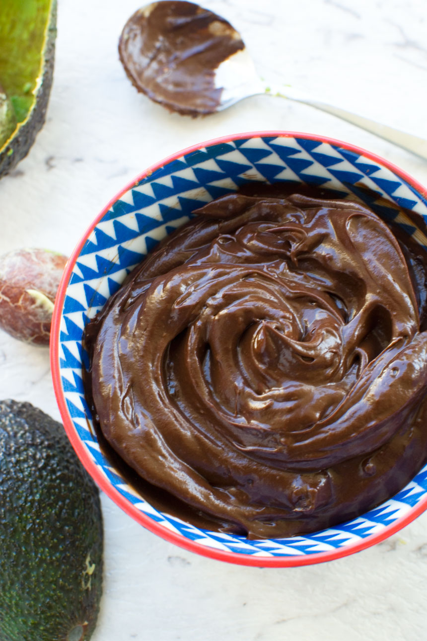 Healthy chocolate frosting from above in a blue and red bowl