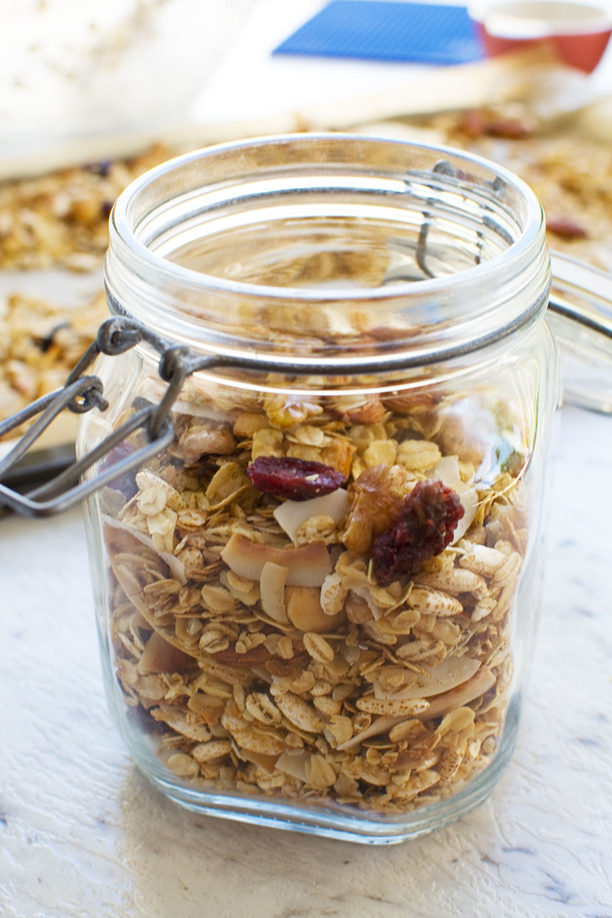 A closeup of homemade granola in a glass container that\'s open