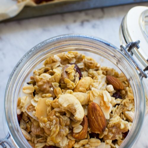 Basic homemade granola in a glass storage jar from above