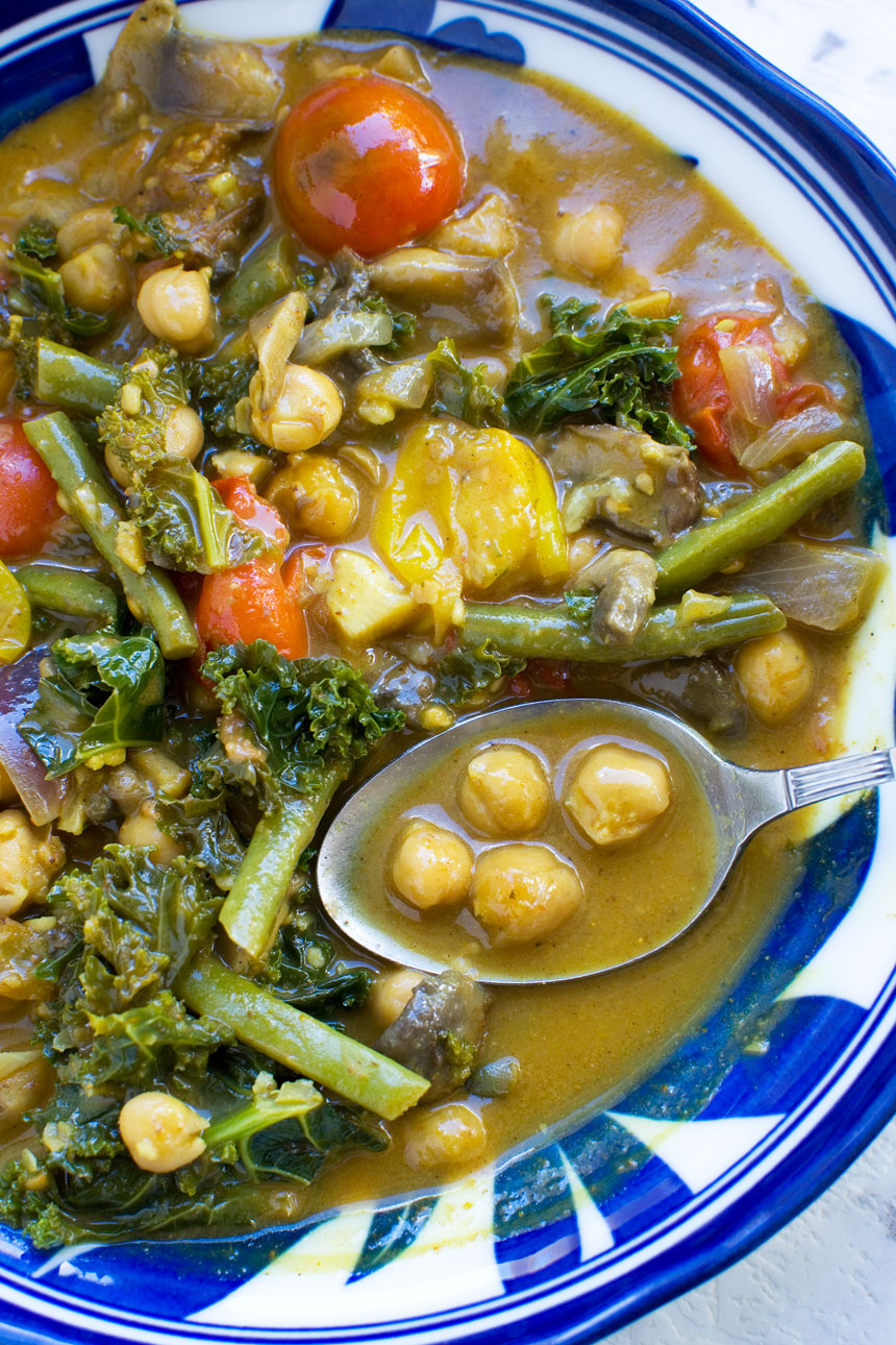 A closeup of a 20-minute coconut chickpea curry with a spoon in it