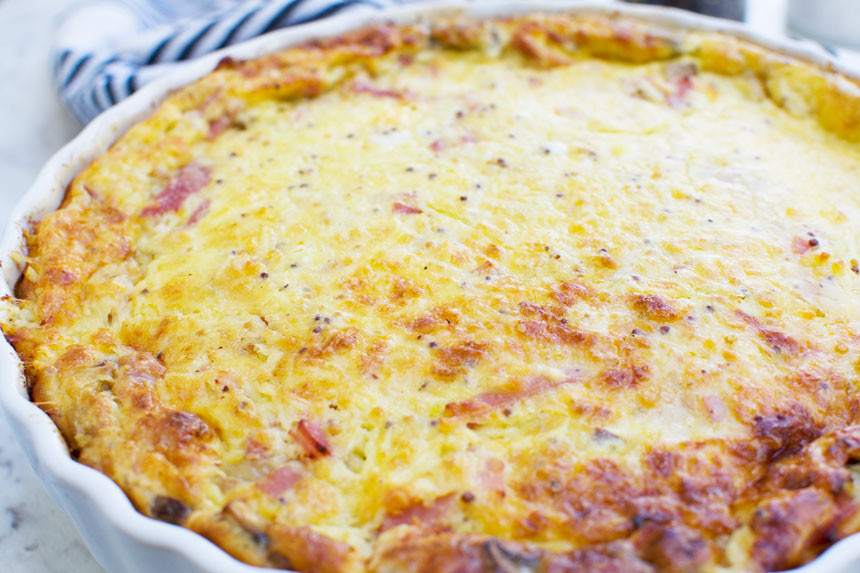 A closeup of a crustless quiche just as it\'s out of the oven