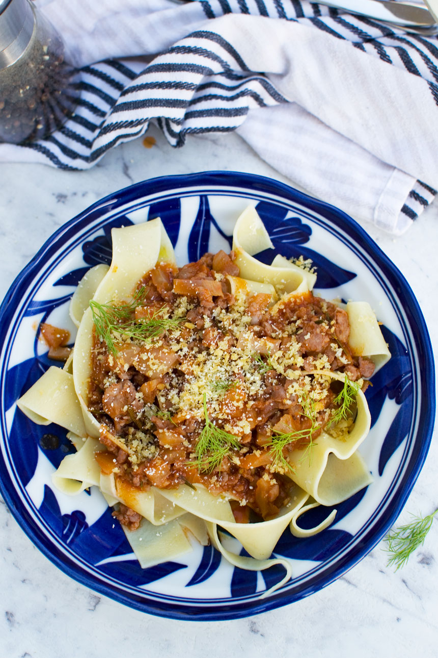 A blue dish of 6-ingredient sausage ragu sauce with fennel pasta from above