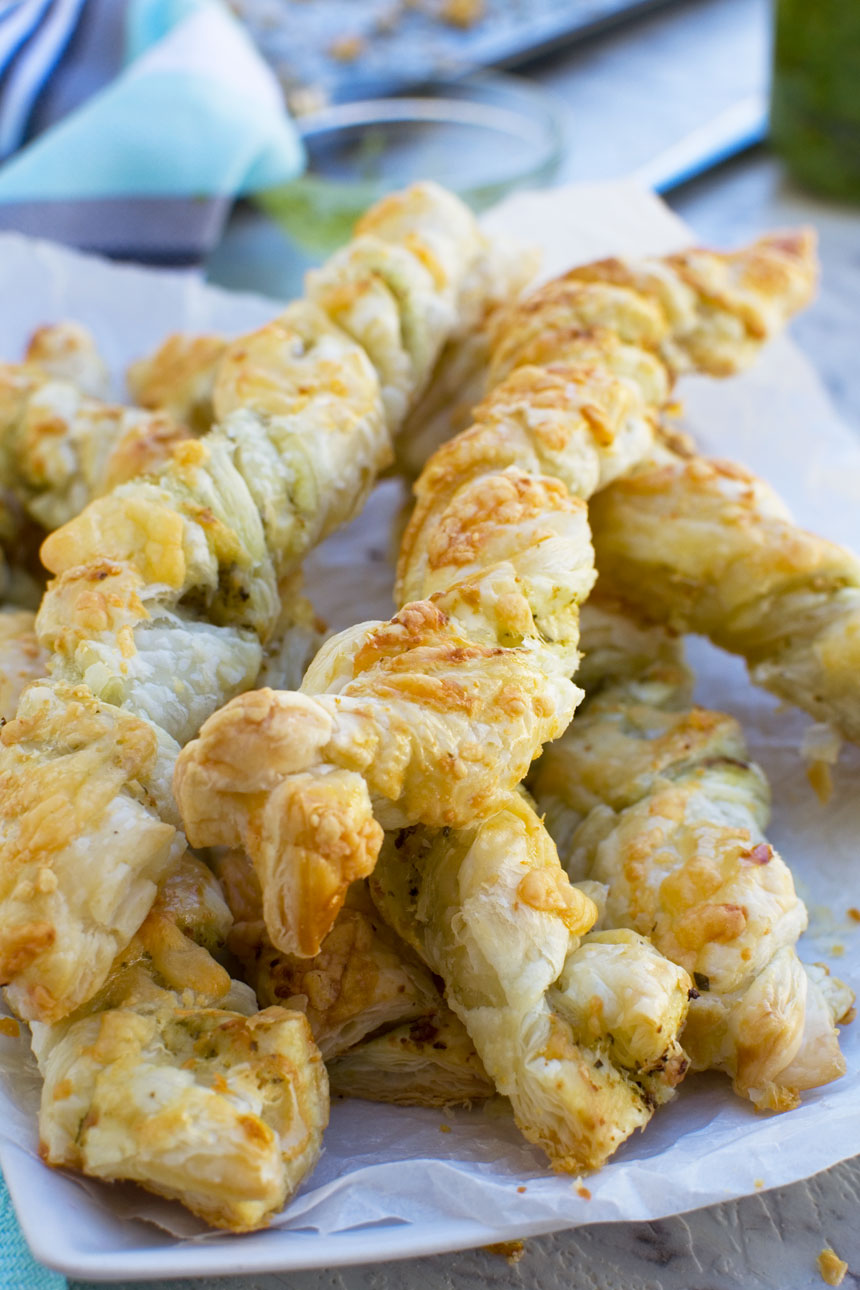 Supermarket copycat pesto and cheese twists piled onto a white plate