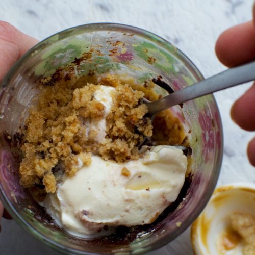 Someone eating 2-minute peanut butter healthy mug cake from above