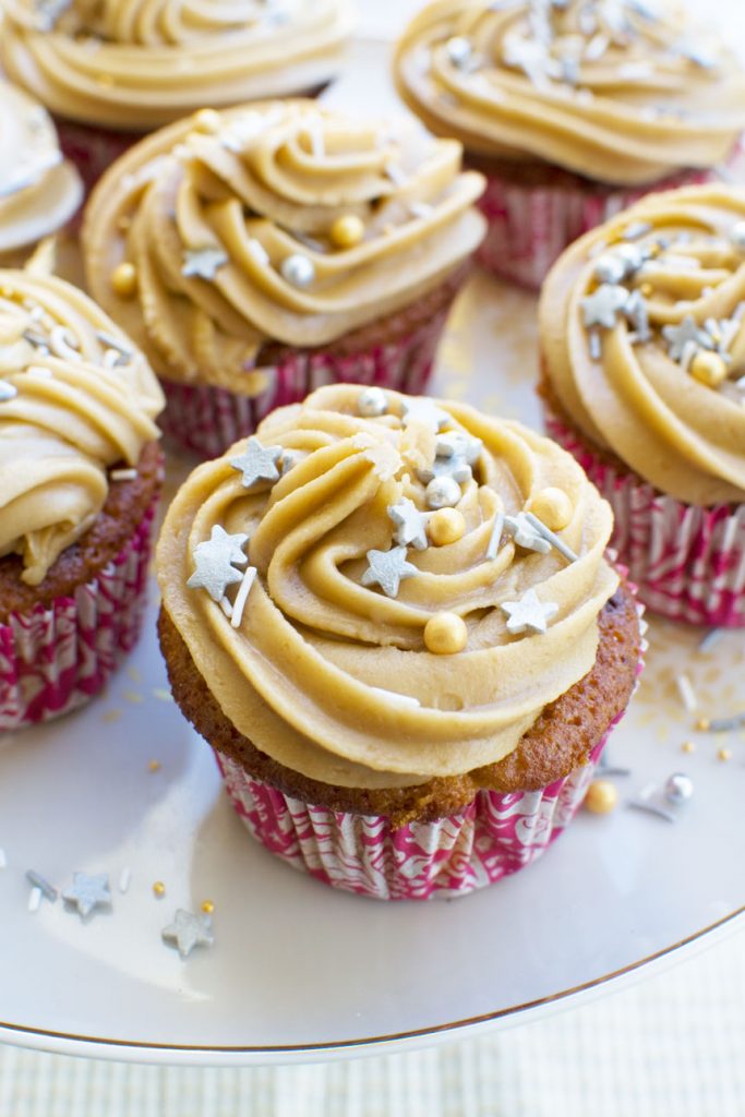 A cake stand with gingerbread muffins with salted caramel icing