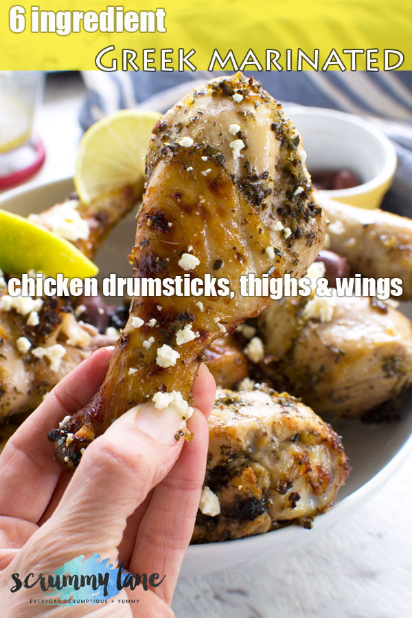 Someone holding up a Greek marinated chicken drumstick - image for Pinterest
