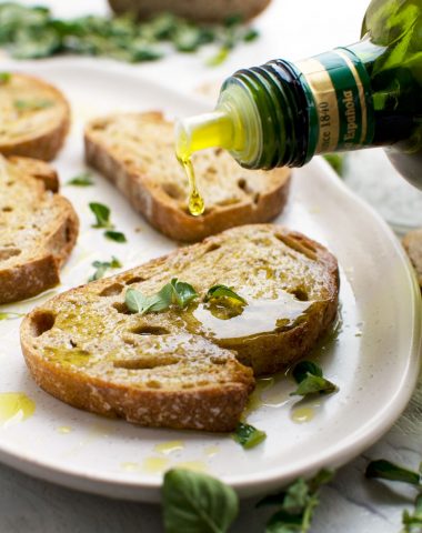 A platter of toasted bread with olive oil and salt