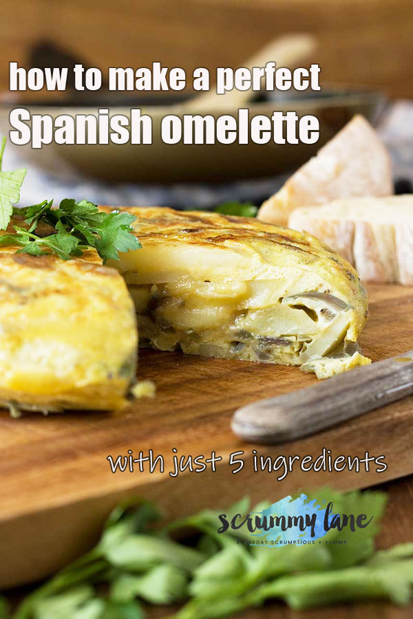 A Spanish omelette with a piece cut out of it on a wooden cutting board