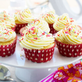 A cake stand full of healthier vanilla cupcakes with 2-ingredient frosting