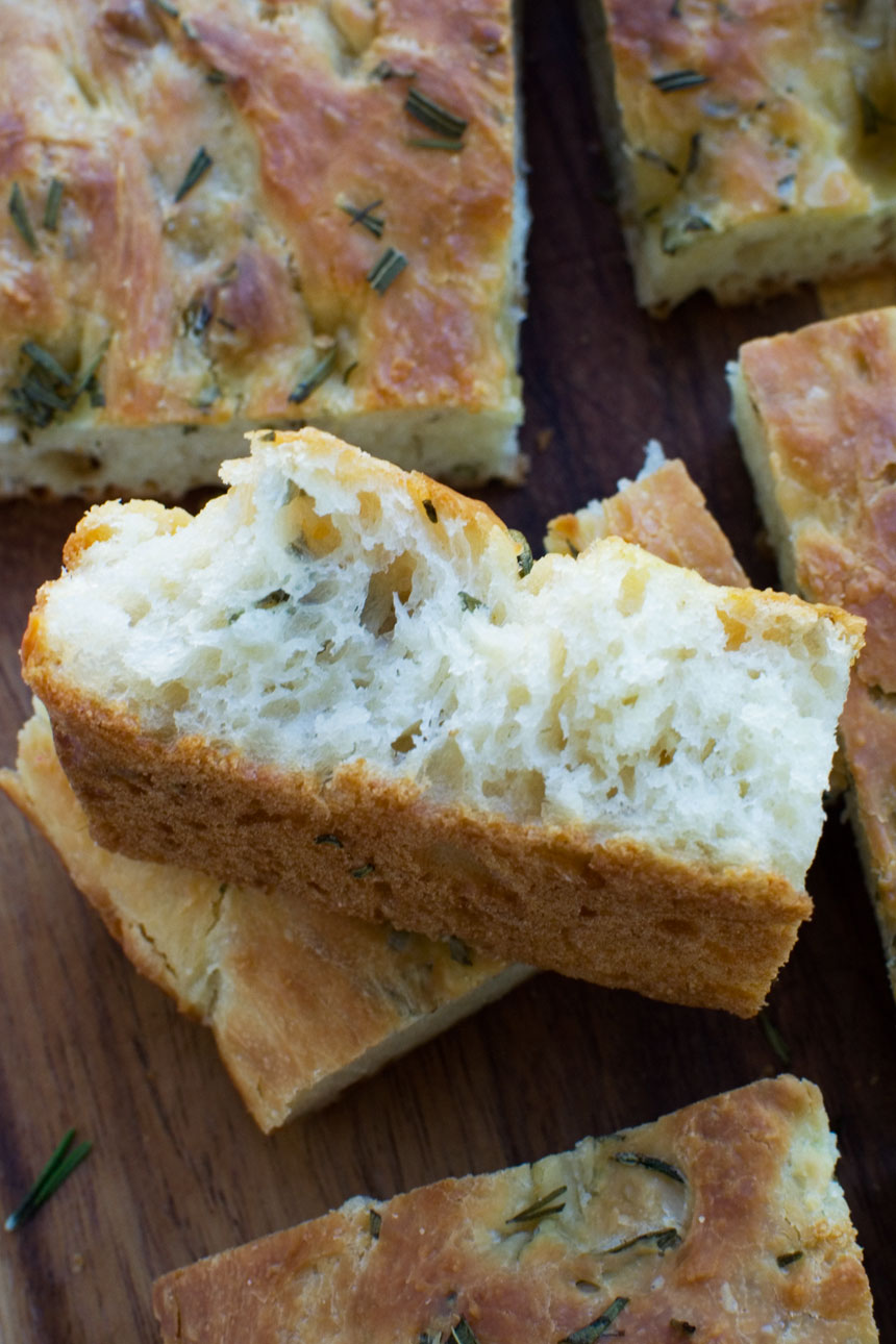 A piece of Italian focaccia bread on its side so you can see the fluffy inside